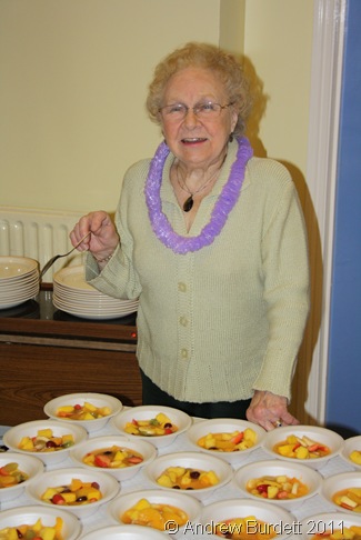 COUNTING THE BOWLS_Marion Brookes ensures there is enough fruit salad to go around.