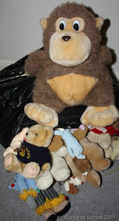 BURSTING AT ITS SEAMS_Mr Monkey guards the bag of stuffed toys.