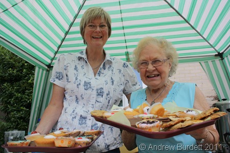 TRY ONE OF THESE_Lin Luff and Marion Brooke offer cakes under the tea gazebo.