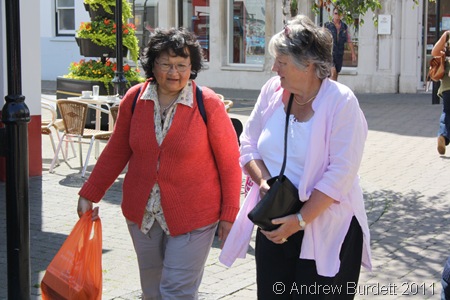 KEEP ON WALKING_Despite sore toes, Fran Hornby wears a smile as she walks through Littlehampton town with a friend.