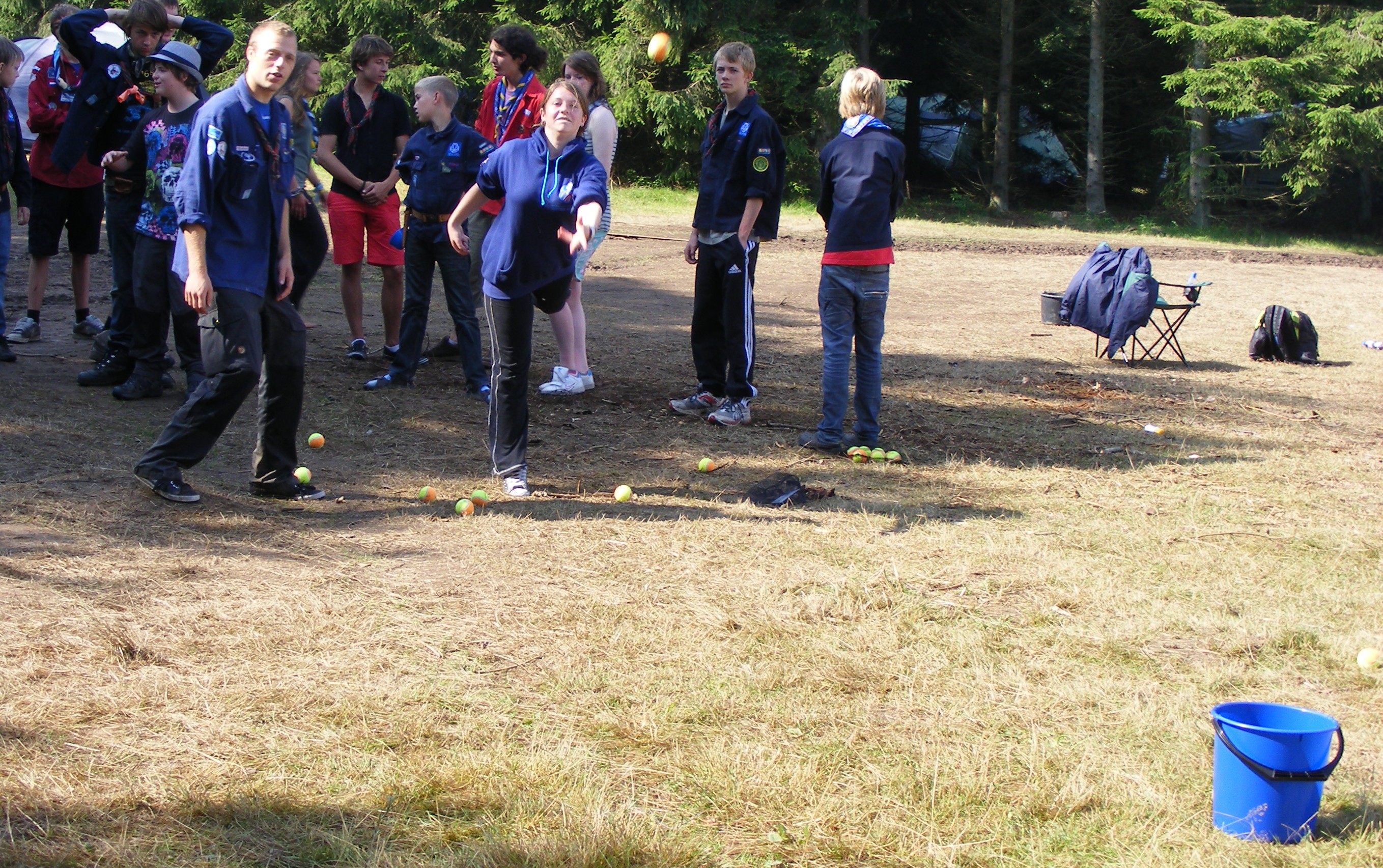 AT IT GIRL_Assistant Patrol Leader Natalie throws a ball in a bucket, during the mini-Olympics event.