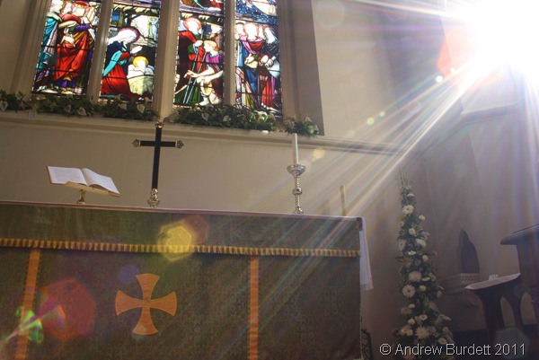 LIGHT FROM GOD_Flowers at the high-altar, with sunlight flooding the east of the church.