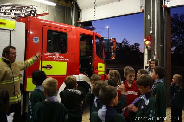 THIS IS THE ENGINE_One of the permanently-based firemen shows the Cubs the fire-engine.