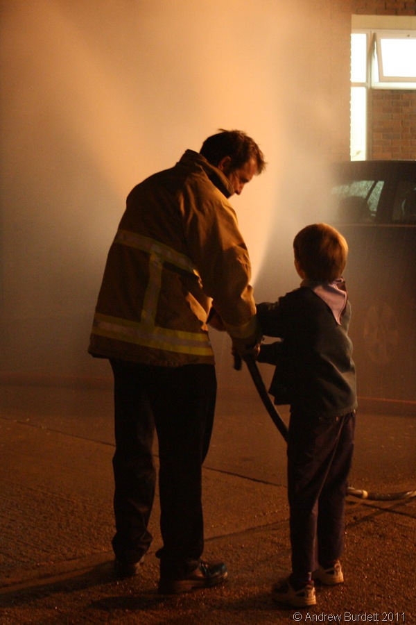 SPRAY_A Cub and the fireman operate the hose.
