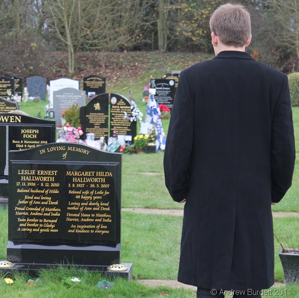 IN MEMORY_Matthew stands refletively in front of the grave of his grandfather and grandmother.