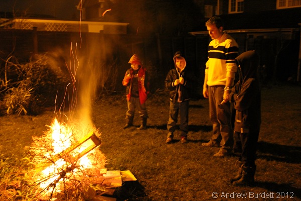 LOGS ON THE FIRE: Luke Darracott stands with younger congregation members as the bonfire burns. (IMG_1043)