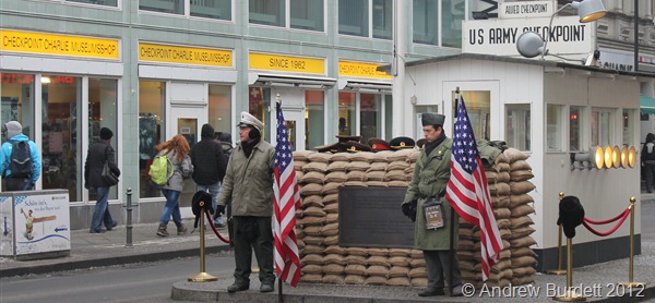 STANDING GUARD: Two men, dressed as US soldiers, pretend to man a mock-up of Checkpoint Charlie for tourists' photographs. (IMG_7695)