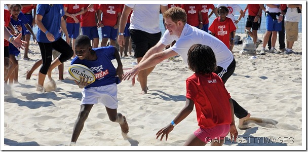 HAVING A BALL: Prince Harry plays sport with Brazilian children on the Rio de Janeiro beach.