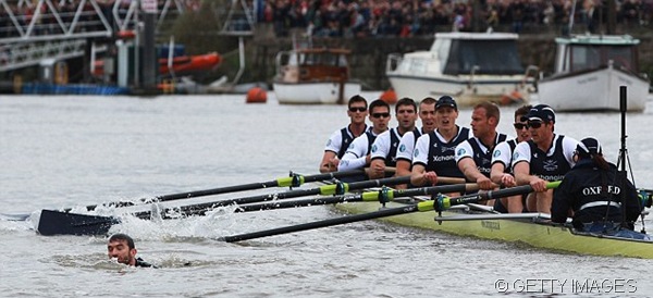 DEATH DEFYING ACT: The swimmer dodged the oars of Oxford's crew.