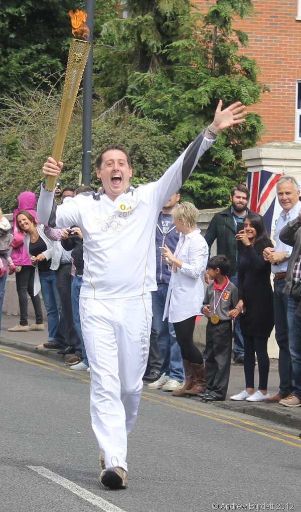 WHAT AN HONOUR: Torchbearer 040 carries the Torch high in the air. (IMG_8875_ARB)