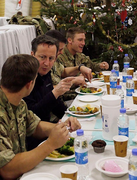 DINNER WITH THE LADS: David Cameron enjoying Christmas dinner with British troops earlier this week. (SNN21042GA---_1641600a)