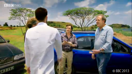 LAB-COAT MAN: An assistant provides details of the real challenge that lies before the presenters- and their cars.