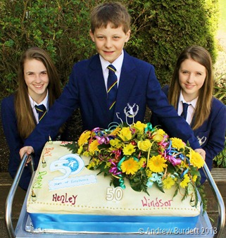 PREPARATION TIME 50 YEARS: Sophie Hurst, Christopher Pearce (the school's youngest student), and Alexandria Piggott with the school's celebratory cake. (IMG_8673-edit_ARB)