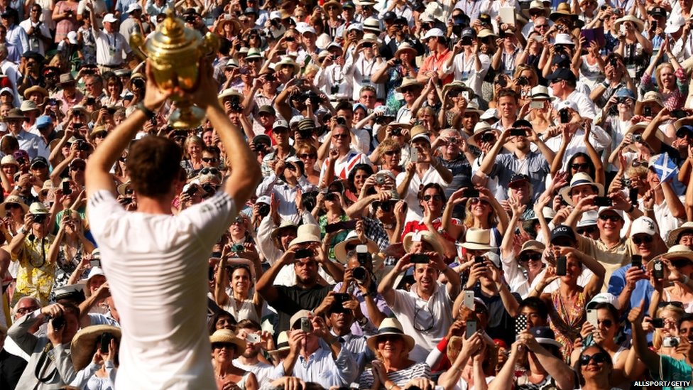 THE WINNING CROWD: Andy Murray displays the trophy to the cheering supporters.