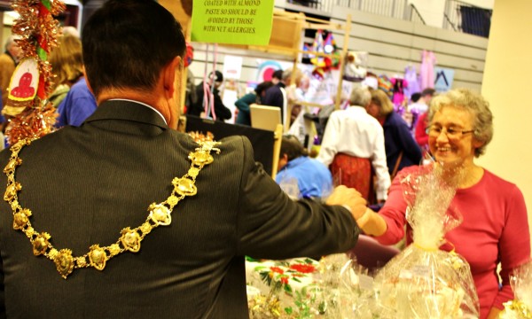 Mayor Andrew Jenner handing over money to the St Luke's stall.