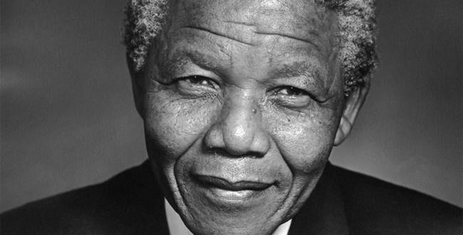 A black-and-white picture of a smiling Nelson Mandela, who died today.