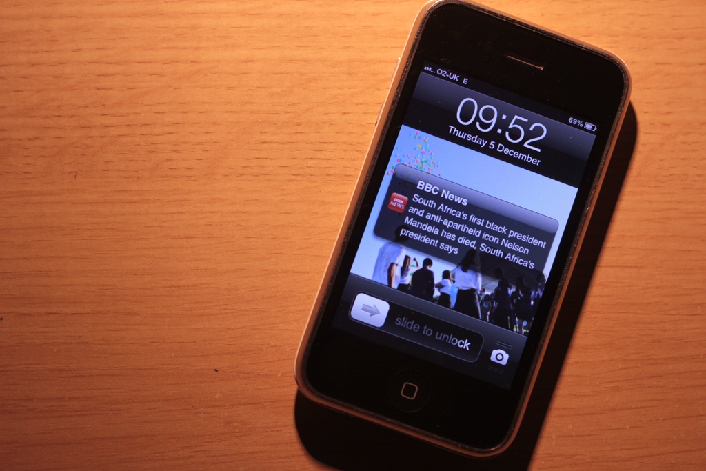 An iPhone with a push notification of Nelson Mandela's death.