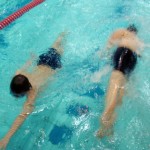 As one St Luke's swimmer completes a two-length 'lap', another sets off.