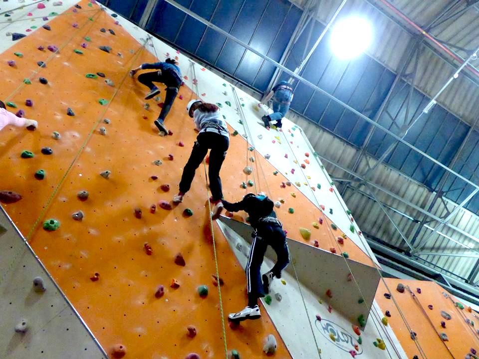 Four youngsters scale the fourteen-metre wall at Reading Climbing Centre, including (far right) Andrew Burdett.