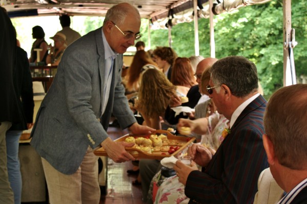 Rhidian Jones serves canapés to guests, once on board.