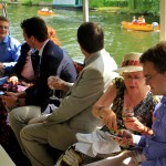 Guests enjoying the pleasant weather from the shelter of the party boat's canopy.
