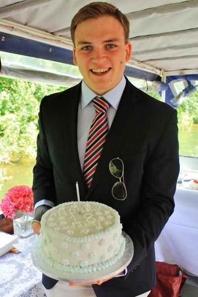 Andrew Burdett holding a cake, made and decorated by father Richard Burdett, in celebration of his 18th birthday party.