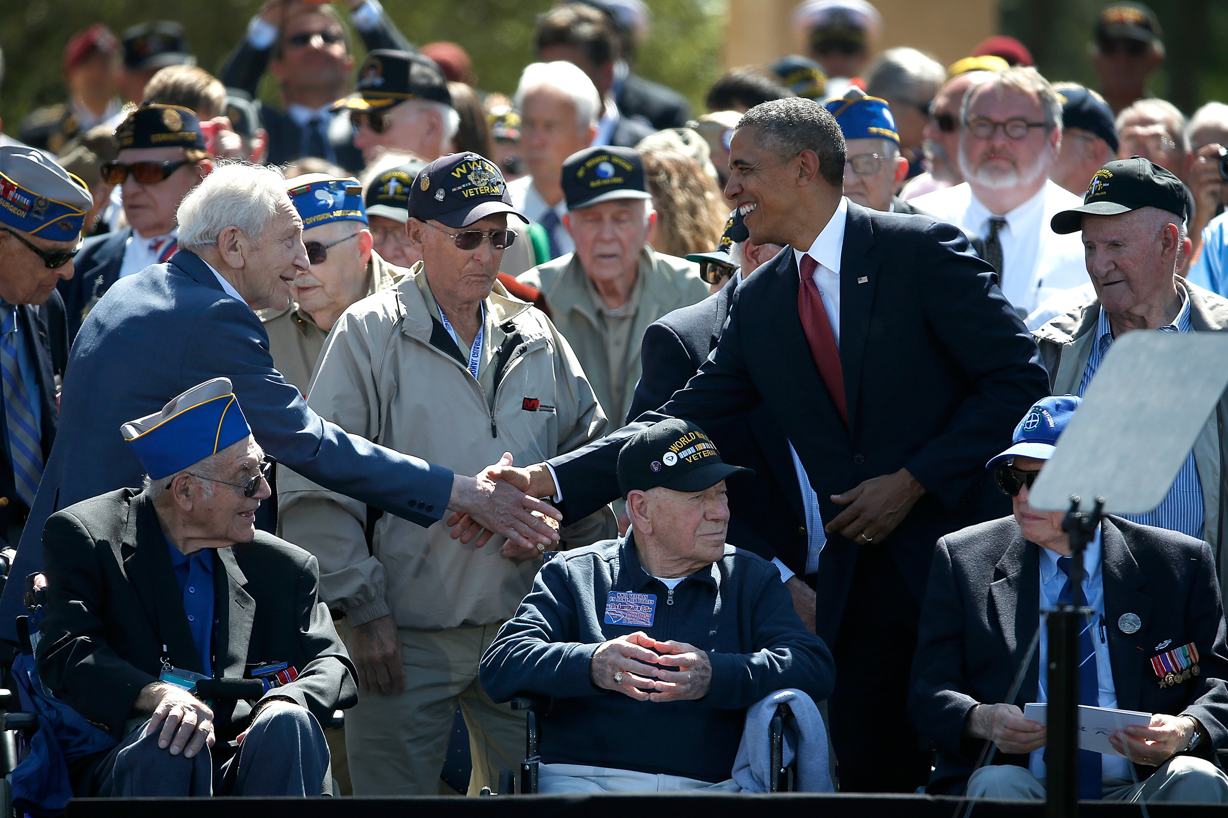 Barack Obama shakes hands with D-Day veterans.