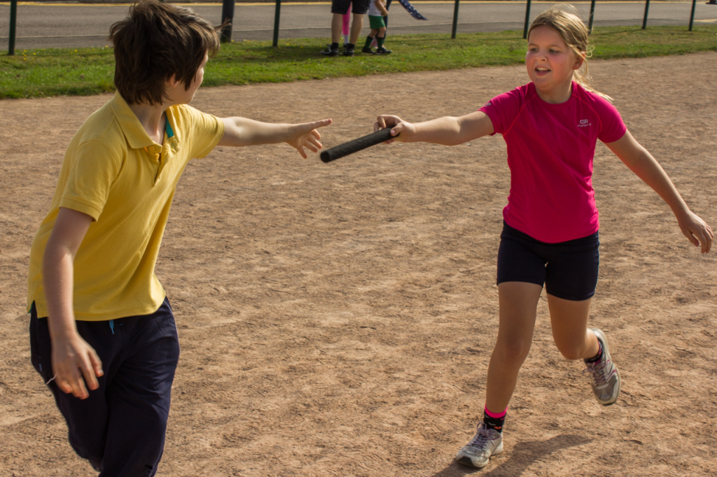 The baton passes from one Scout to another.