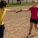 The baton passes from one Scout to another.