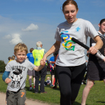 A Beaver Scout with his mum begin their half-lap.