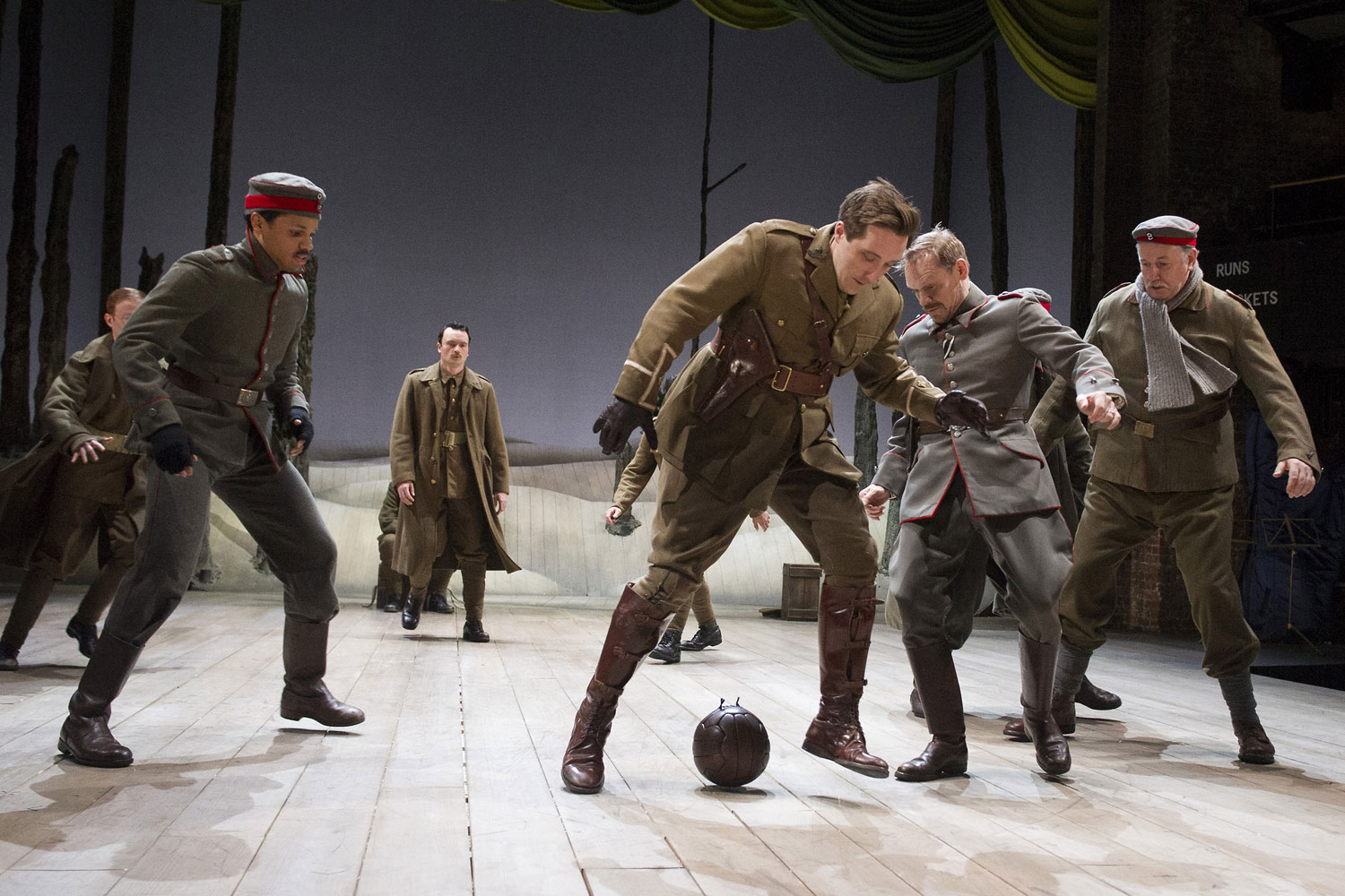 Warring soldiers playing football during a scene in 'The Christmas Truce'.