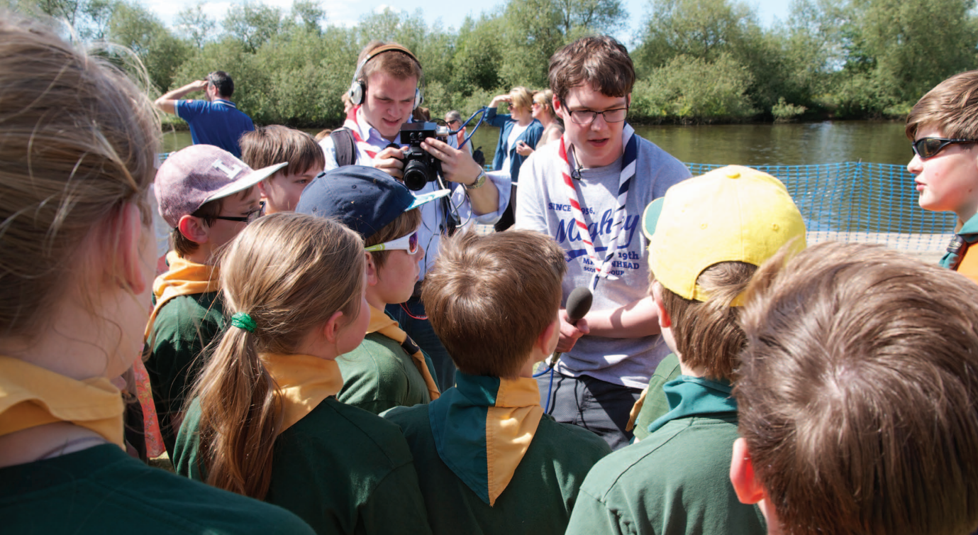Photograph, taken from the Berkshire Scouts Annual Review, showing Andrew Burdett and Loz Marchant filming a vox-pops video.