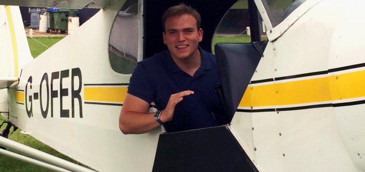 Andrew Burdett sat in the passenger seat of a PA-18 150 Super Cub at White Waltham Airfield.