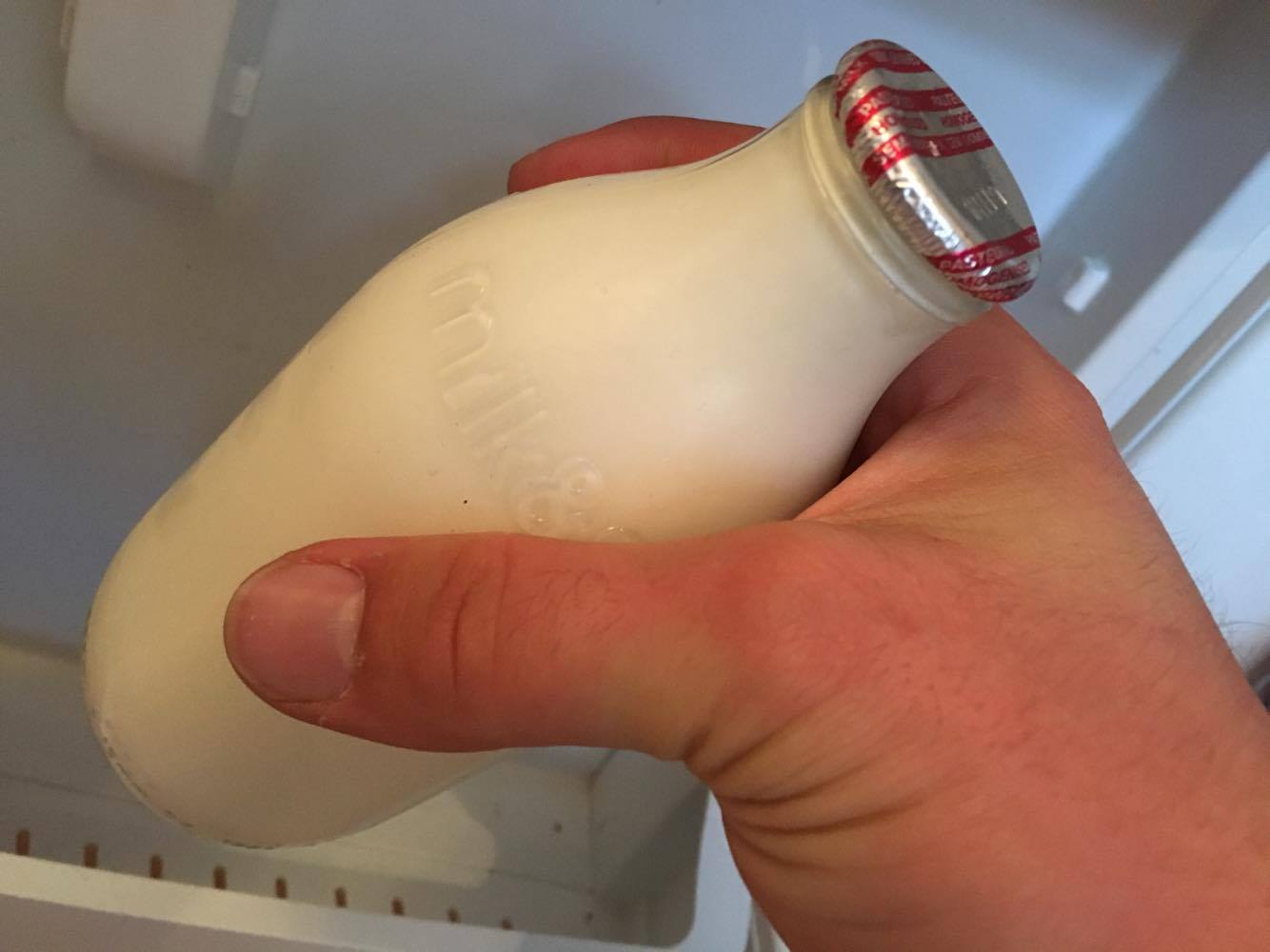 An errant hand thieves a pint of milk.